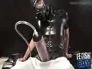 BDSM sicko in leather outfit plays with a cock pump