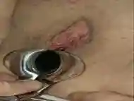 Closeup pussy stimulation with a speculum inserted inside of it