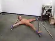 Naked man exposed to BDSM and bondage on the floor