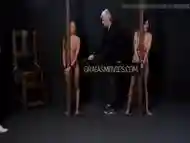 Two female slaves get their asses caned by their master