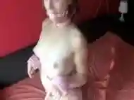 Young brunette tied to the bed has sex while having dildo in her