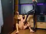 Prostate Massage Femdom Bdsm. Mistress In A Latex Catsuit Gives A Prostate Massage To A Slave With Mistress Latex