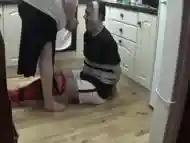 Footballer tied and taped tight on kitchen floor