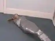 Blonde girl wrapped in duct tape struggles