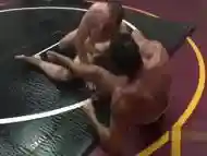 Hunky stud strips during wrestling