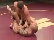 Inked wrestler pins down his muscly opponent