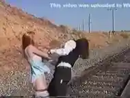 Ticklish Damsel Tickled on Railroad Tracks (nylon bare feet tickling)