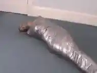 Blonde girl wrapped in duct tape struggles