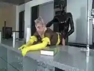 Kinky dude in a latex suit fucks his plump maid slave