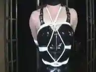 Hooded Bondage Babe In LIngerie Tied To Post