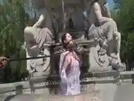 Teen slave bathing in public fountain