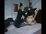 Brunette whore gets tied down to a bed, gagged and flogged by two horny lesbians