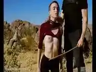 Petite, hardcore submissive masochist Brooke Johnson drinks piss, gets a hard caning, and get a severe facesitting rimjob session on the desert rocks of Joshua Tree in this Domthenation documentary