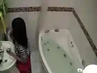 Bathroom camera records a kinky Asian rubbing her juicy vagin